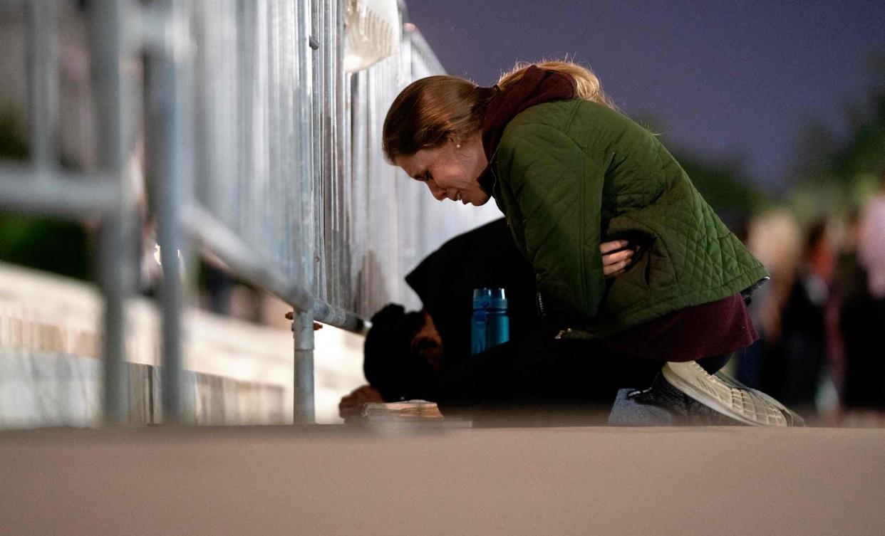 <span class="caption">A women cries while kneeling in front of the U.S. Supreme Court in Washington, D.C., on May 2, 2022.</span> <span class="attribution"><a class="link " href="https://www.gettyimages.com/detail/news-photo/women-cries-while-kneeling-in-front-of-the-us-supreme-court-news-photo/1240411918?adppopup=true" rel="nofollow noopener" target="_blank" data-ylk="slk:Stefani Reynolds/AFP via Getty Images;elm:context_link;itc:0;sec:content-canvas">Stefani Reynolds/AFP via Getty Images</a></span>