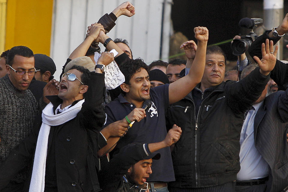 FILE - In this Feb. 8, 2011 file photo, Egyptian Wael Ghonim, center, talks to the crowd in Tahrir Square, in Cairo, Egypt. Ghonim said late Thursday, Sept. 19, 2019 in a video on his twitter account that authorities raided his parents' house in Cairo and arrested his brother Hazem, whom he described as "a political person" and confiscated his parents' passports. Ghonim alleges that the Egyptian embassy in the U.S. threatened him the previous day "something will happen" if he didn't stop criticizing Egypt's government on social media. (AP Photo/Tara Todras-Whitehill, File)