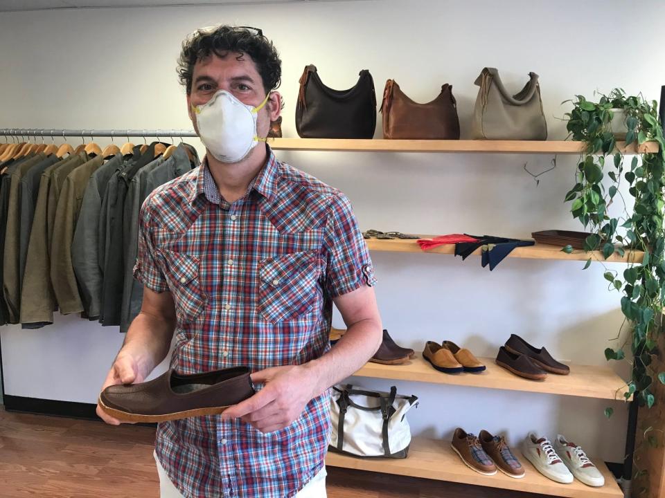 Matt Renna of Queen City Dry Goods holds a house shoe his company makes in a photo from 2020.