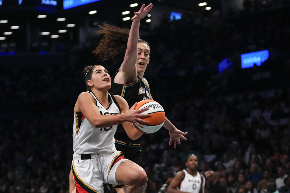 Las Vegas Aces' Kelsey Plum drives past New York Liberty's Breanna Stewart during the first half in Game 3 of a WNBA basketball final playoff series, Sunday, Oct. 15, 2023, in New York. (AP Photo/Frank Franklin II)