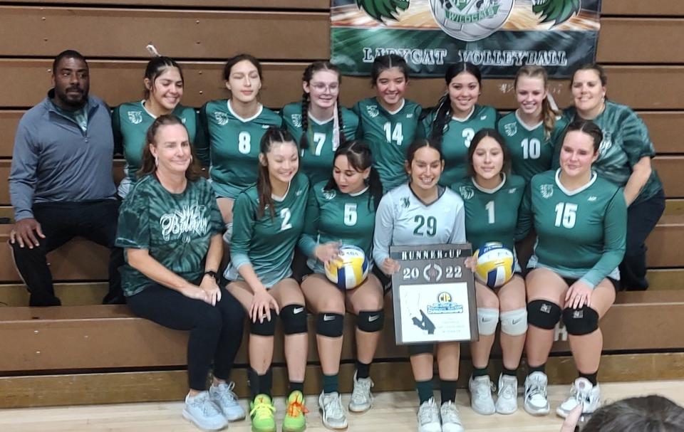 The Twentynine Palms volleyball team poses with the runner-up trophy on Saturday.