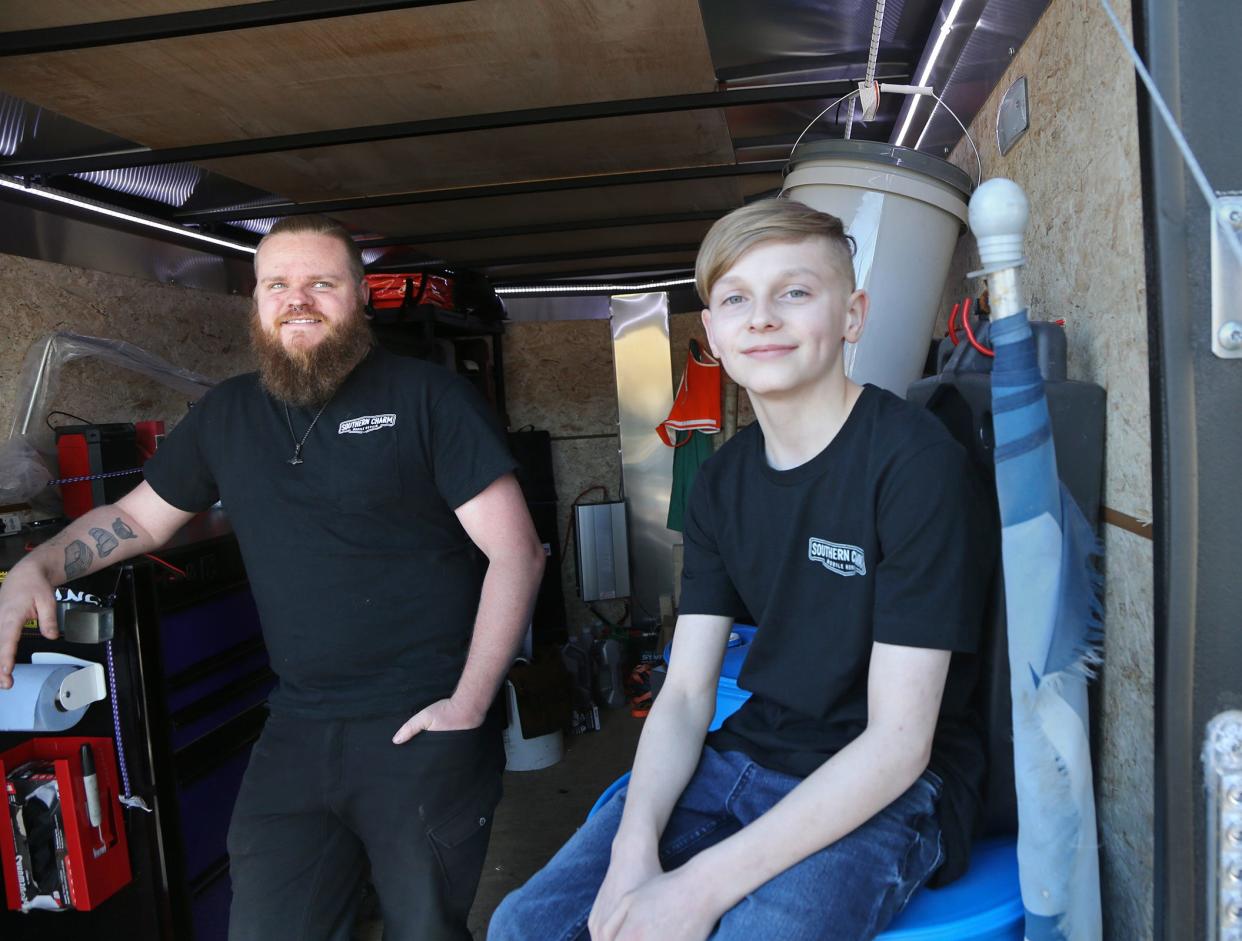 Blake Hicks and his son Bentley hanging out in the Southern Charm Mobile Auto Repair unit in York. Hicks recently launched Southern Charm to help customers who have a hard time leaving their house or who need serious repairs on the roadside.