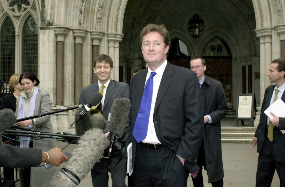 Piers Morgan (centre), editor of The Mirror, leaves the High Court in London after supermodel Naomi Campbell won  3,500 damages from the newspaper following a ruling that it acted in breach of confidence in publishing details of her therapy at Narcotics Anonymous.  