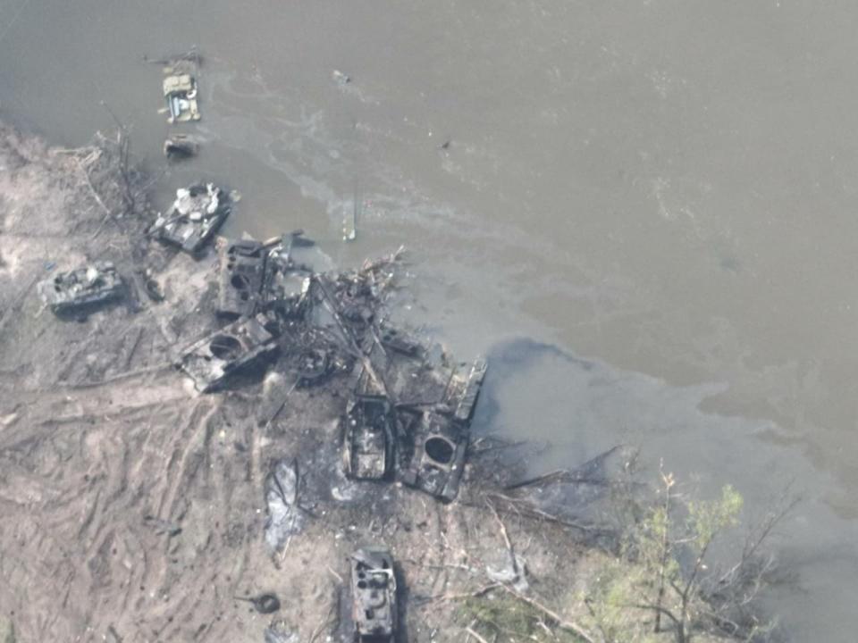This image released by the Ukrainian military appears to show wrecked Russian armor assets on the river bank.