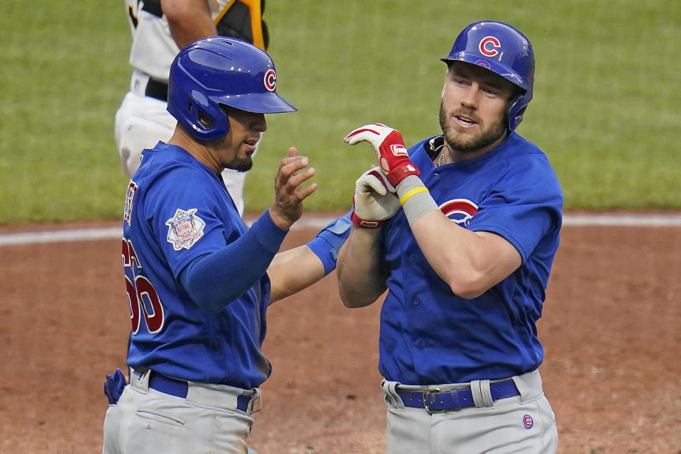 Chicago Cubs' Patrick Wisdom, right, is greeted by Rafael Ortega as he returns to the dugout after hitting a two-run home run off Pittsburgh Pirates starting pitcher Jerod Eickhoff during the fourth inning of a baseball game in Pittsburgh, Wednesday, June 22, 2022. (AP Photo/Gene J. Puskar)