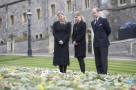 Britain's Prince Edward, Lady Louise Windsor and Sophie Countess of Wessex, right to left, view flowers outside St George's Chapel, at Windsor Castle, Windsor England, Friday April 16, 2021, ahead of the Saturday funeral service for Britain's Prince Philip. Prince Philip died at the age of 99 on April 9. (Steve Parsons/Pool via AP)