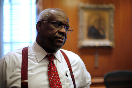 FILE PHOTO: U.S. Supreme Court Justice Clarence Thomas is seen in his chambers at the U.S. Supreme Court building in Washington, U.S. June 6, 2016. REUTERS/Jonathan Ernst/File Photo