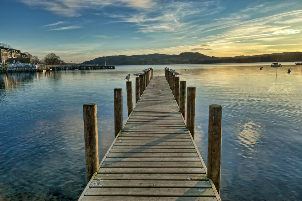 A jetty on Windermere in the English Lake District at sunset.