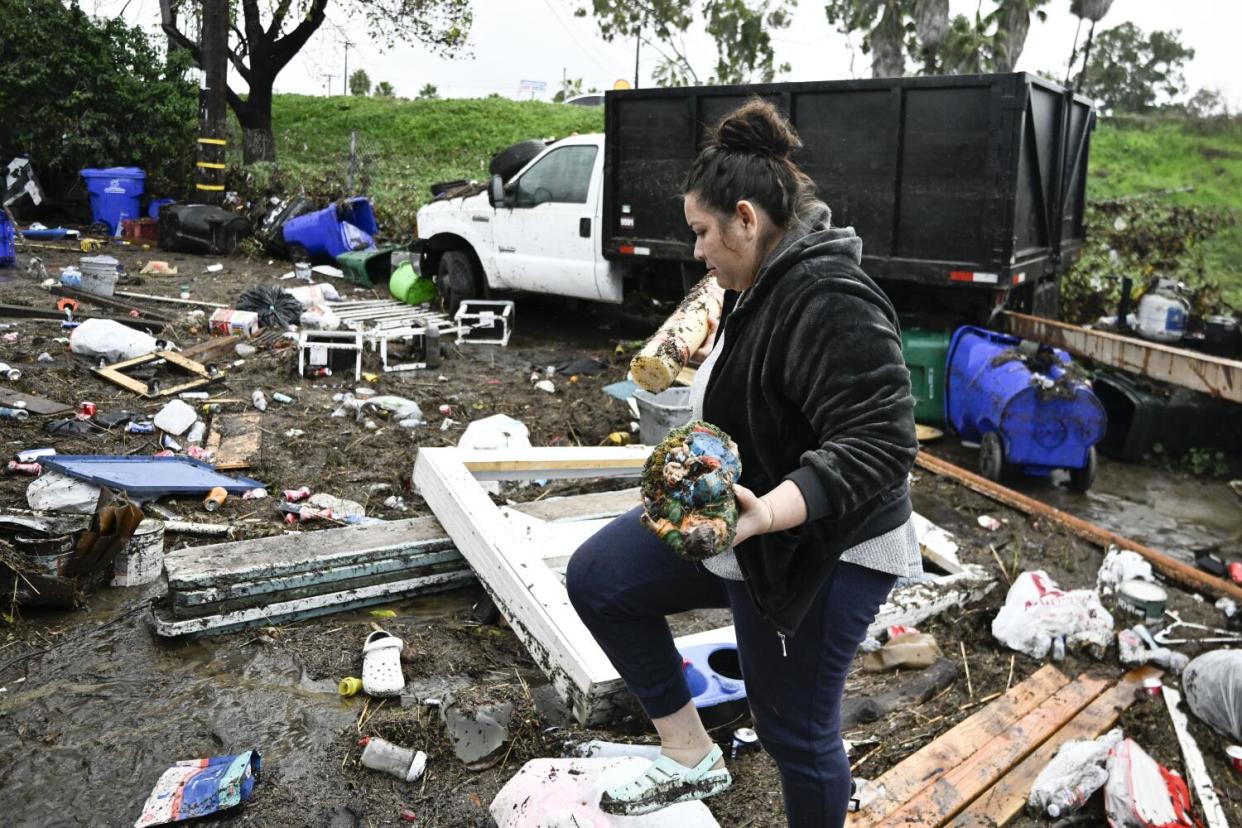 Marlene Sanchez-Barriento salvages items behind her home