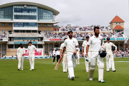 Cricket - England v India - Third Test - Trent Bridge, Nottingham, Britain - August 20, 2018 India's Virat Kohli and Cheteshwar Pujara leave the field for the lunch interval Action Images via Reuters/Paul Childs