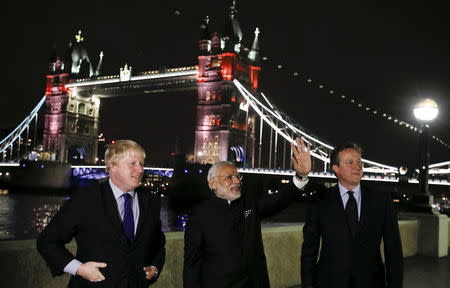 Britain's Prime Minister David Cameron (R), India's Prime Minister Narendra Modi (C) and London Mayor Boris Johnson acknowledge the public in front of Tower Bridge in London, November 12, 2015. REUTERS/Kirsty Wigglesworth/Pool