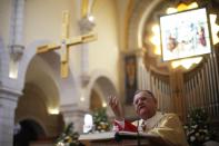 The Latin Patriarch of Jerusalem Fouad Twal gestures as he speaks while leading a Catholic mass at the Church of St. Catherine, which is connected to the Church of Nativity, in the West Bank town of Bethlehem on Christmas day December 25, 2013. REUTERS/Mohamad Torokman (WEST BANK - Tags: RELIGION)