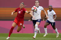 Canada's Janine Beckie, left, and United States' Tierna Davidson battle for the ball during a women's semifinal soccer match at the 2020 Summer Olympics, Monday, Aug. 2, 2021, in Kashima, Japan. (AP Photo/Fernando Vergara)