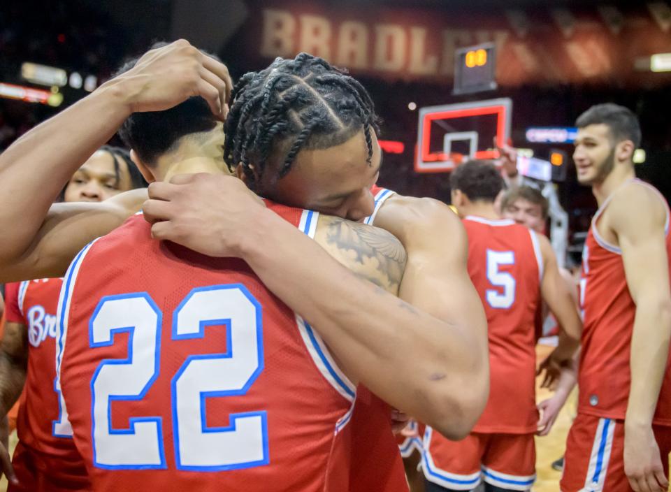 Bradley's Ja'Shon Henry (22) and teammate Zek Montgomery share a hug after the Braves clinched the MVC championship with a 73-61 victory over Drake in the regular-season finale Sunday, Feb. 26, 2023 at Carver Arena.