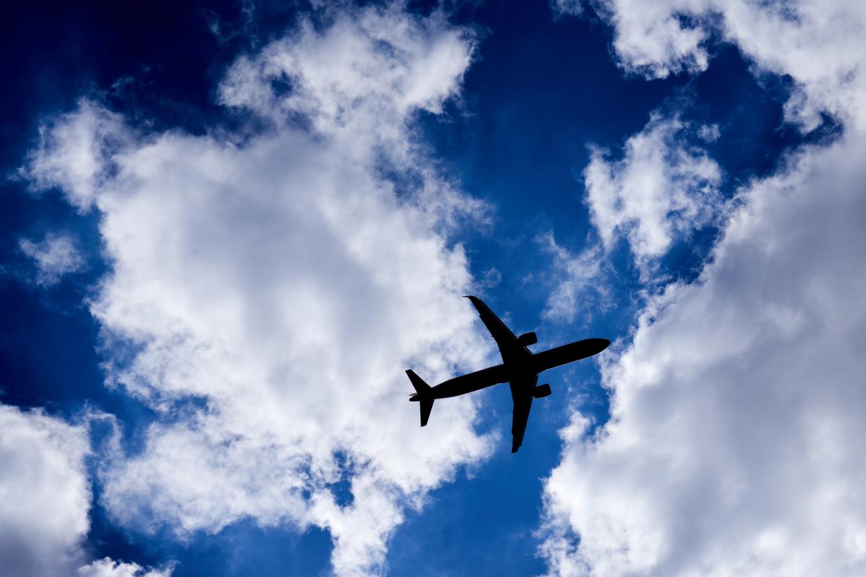 A silhouette of a plane as it passes overhead in Isleworth, West London (PA Archive)