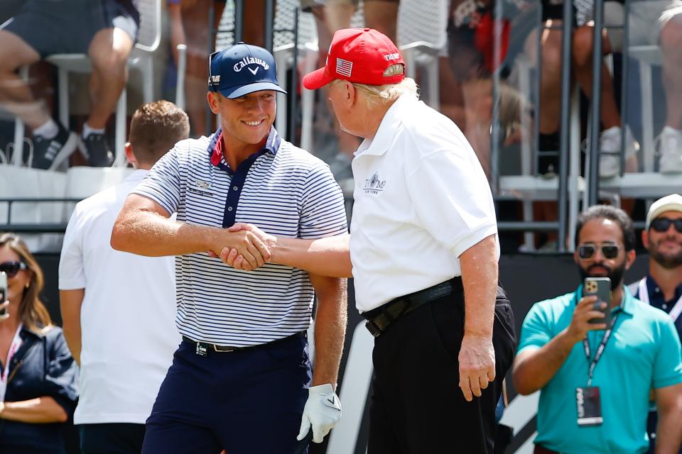 Talor Gooch, seen here with former president Donald Trump at the LIV Golf event in New Jersey, is one of three players seeking to rejoin the PGA Tour's playoffs. (Rich Graessle/Icon Sportswire via Getty Images)