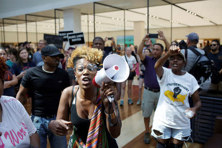 People march through West County Mall a day after the not guilty verdict in the murder trial of Jason Stockley, a former St. Louis police officer, charged with the 2011 shooting of Anthony Lamar Smith, who was black, in St. Louis, Missouri, U.S., September 16, 2017. REUTERS/Joshua Lott