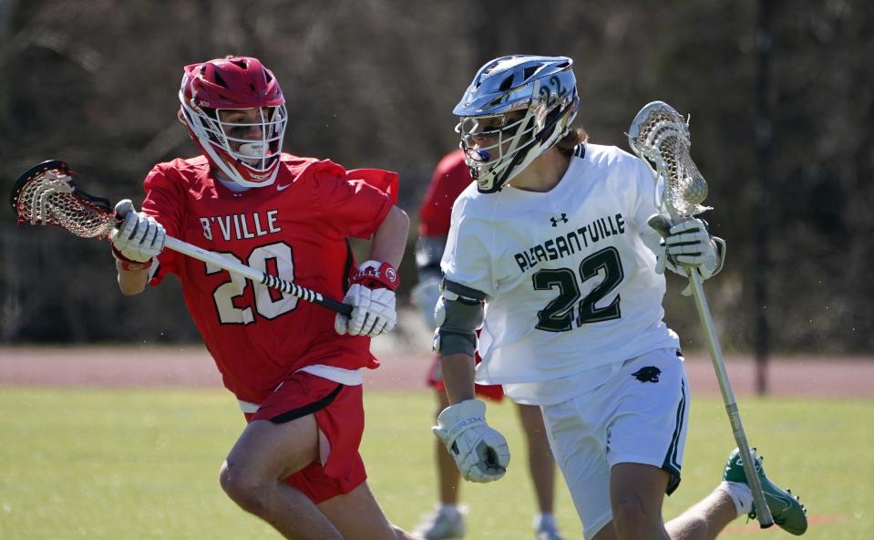 Pleasantville's Emmet McDermott (22) works against Baldwinsville's Joesph Saraceni (20) during boys lacrosse action against Baldwinsville at Pleasantville High School on Saturday, March 30, 2024. Pleasantville won 9-4.