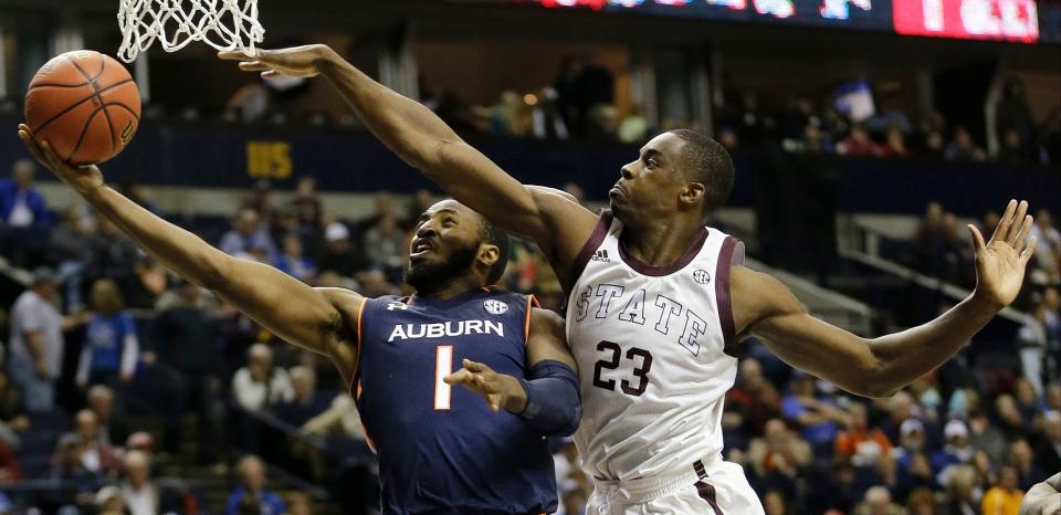 Auburn guard KT Harrell (1) shoots against Mississippi State guard Travis Daniels (23) during the second half of an NCAA college basketball game in the first round of the Southeastern Conference tournament, Wednesday, March 11, 2015, in Nashville, Tenn. Auburn won 74-68.