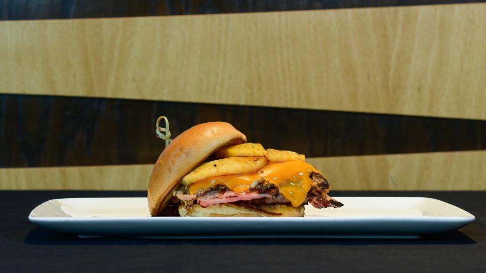 The RubberDucks WAKR Hawaiian Burger is a 4-ounce patty with smoked pulled chicken, Canadian bacon and pineapple rings with a teriyaki glaze drizzle.