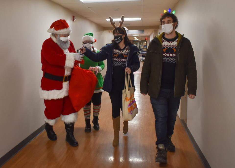 Santa, his elf, reindeer and the reindeer's boyfriend make their way down the hallway at Wilson Hospital on Christmas Eve.