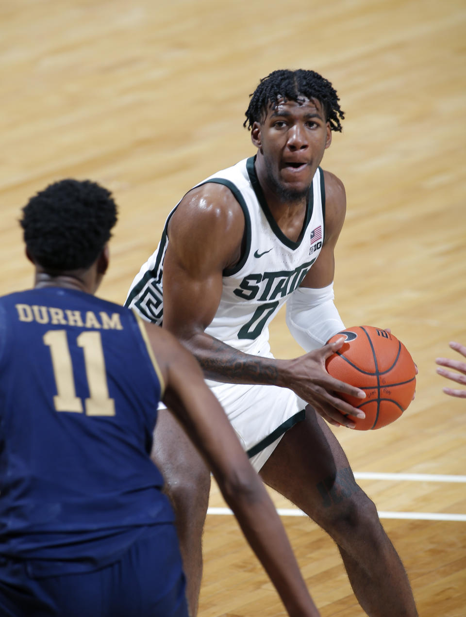 Michigan State's Aaron Henry, right, looks to drive against Notre Dame's Juwan Durham (11) during the second half of an NCAA college basketball game Saturday, Nov. 28, 2020, in East Lansing, Mich. Michigan State won 80-70. (AP Photo/Al Goldis)