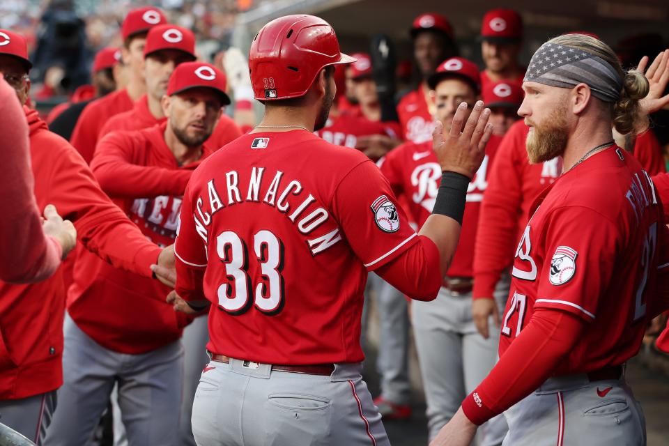 Christian Encarnacion-Strand #33 of the Cincinnati Reds celebrates with teammates after scoring a run in the second inning against the Detroit Tigers at Comerica Park on Sept. 13, 2023.