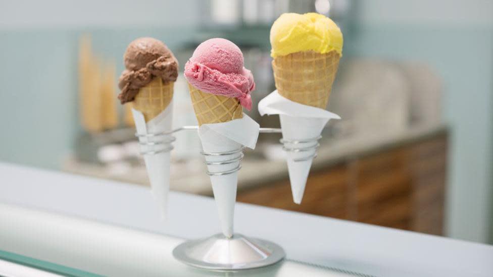 Cones of chocolate, strawberry and lemon ice cream in a holder