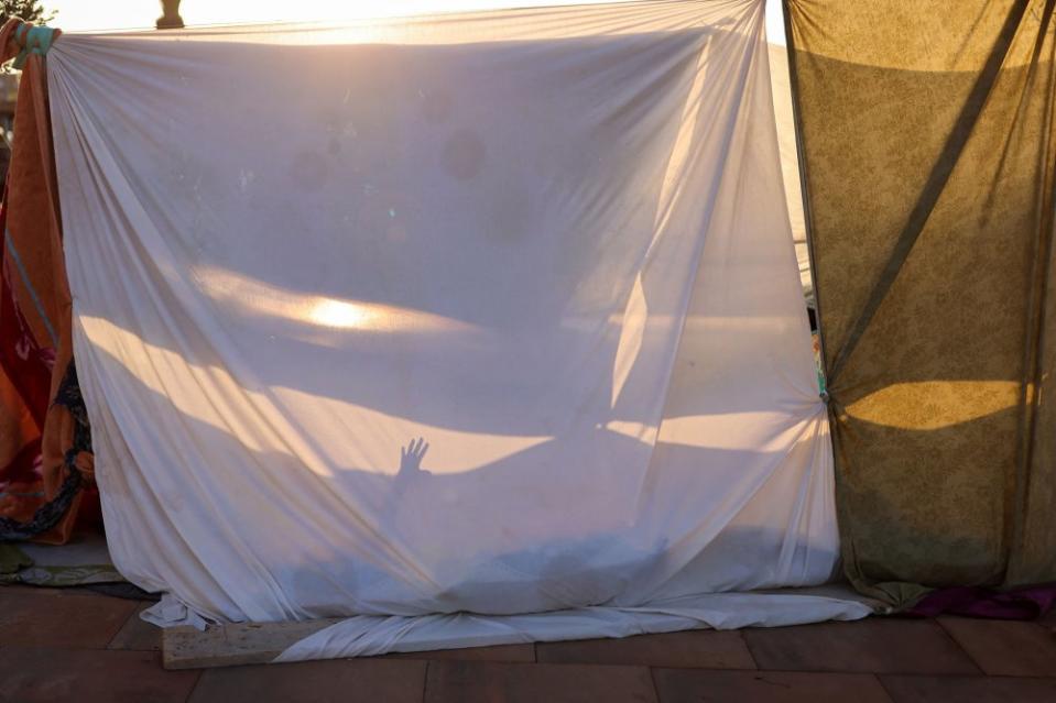 A resident rests in a makeshift shelter on a street next to a Gare Routiere, in the aftermath of a deadly earthquake, in Marrakech, Morocco, on Sept. 10.<span class="copyright">Nacho Doce—Reuters</span>