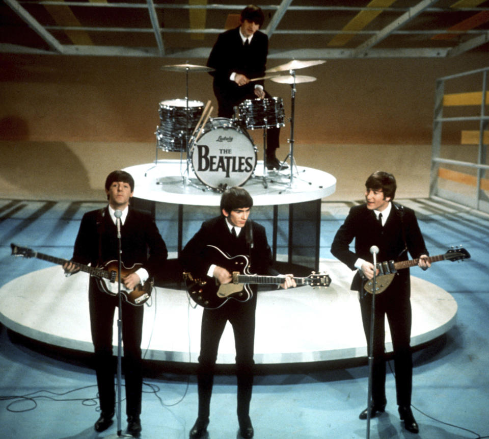 FILE -The Beatles, foreground from left, Paul McCartney, George Harrison, John Lennon and Ringo Starr on drums perform on the CBS "Ed Sullivan Show" in New York on Feb. 9, 1964. Sixty years after the onset of Beatlemania and with two of the quartet now dead, artificial intelligence has enabled the release of a “new” Beatles song.“Now And Then,” will be available Thursday, Nov. 2. (AP Photo/File)