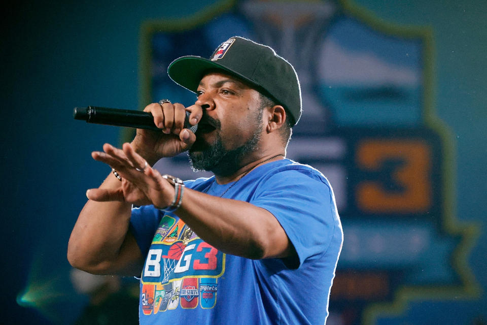 Ice Cube speaks into a microphone while wearing a Big3 t-shirt.