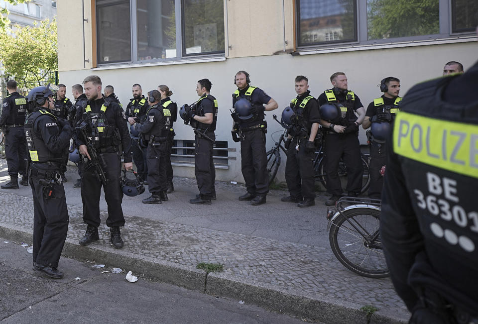 Police officers stand outside the 'Protestant School Neukoelln' in Berlin, Germany, Wednesday, May 3, 2023. Berlin police say two young children were seriously wounded in an attack at a school in the south of the capital. Police said the victims were girls aged 7 and 8 years. One is in a life-threatening condition, they said in a statement. (Michael Kappeler/dpa via AP)