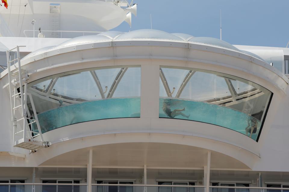 A passenger swims in a swimming pool in the 'Wonder of the Seas' cruise ship of the company Royal Caribbean, the world's largest cruise ship, docked at a port in Malaga, Spain, April 30, 2022. REUTERS/Jon Nazca