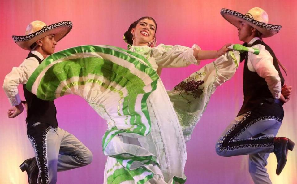 Angelina Manquero is flanked by Ezekiel Flores and Joseph Romero in a performance of ‘Pelea de Gallos’ from Aguascalientes at Central East Danzantes de Tláloc 25th anniversary show at the Performing Arts Center on May 26, 2023.