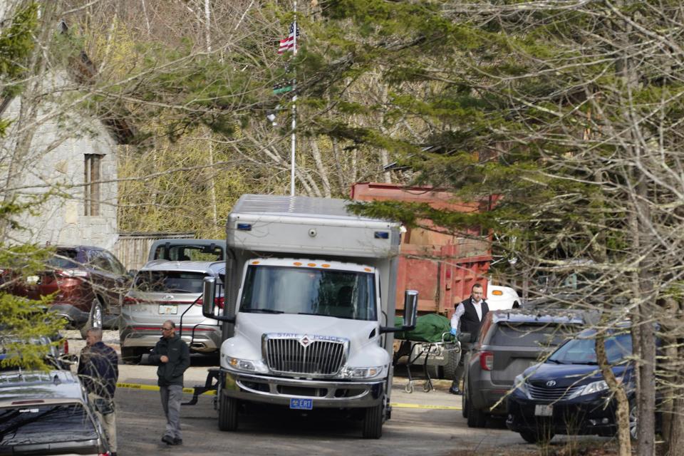 A body is wheeled to a hearse at the scene of a shooting, Tuesday, April 18, 2023, in Bowdoin, Maine. (AP Photo/Robert F. Bukaty)