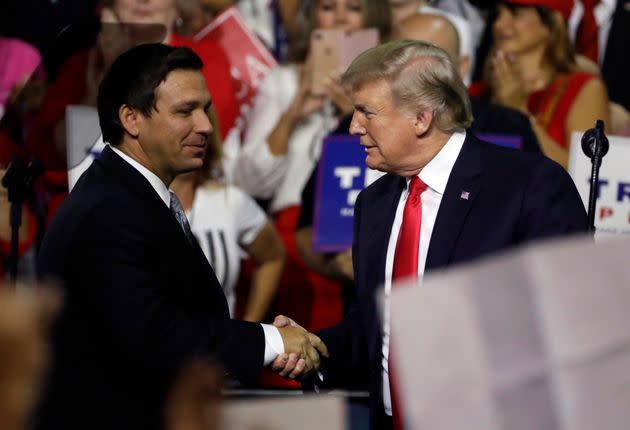 President Donald Trump shakes hands with Ron DeSantis, then a Republican candidate for governor of Florida, at a July 31, 2018, rally in Tampa. (Photo: Chris O'Meara/Associated Press)