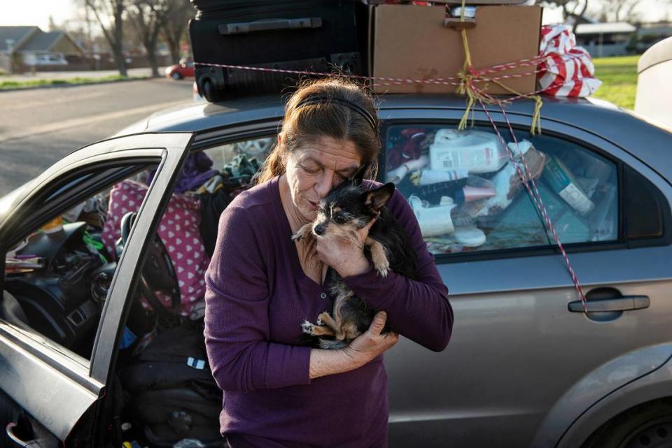 Ladonna Doshier with her dog Li’l Miss Missy at Fairway Park in Modesto, Calif., on Wednesday, Jan. 5, 2022. Doshier is homeless and living in her car and finds comfort in the companionship of her dog.
