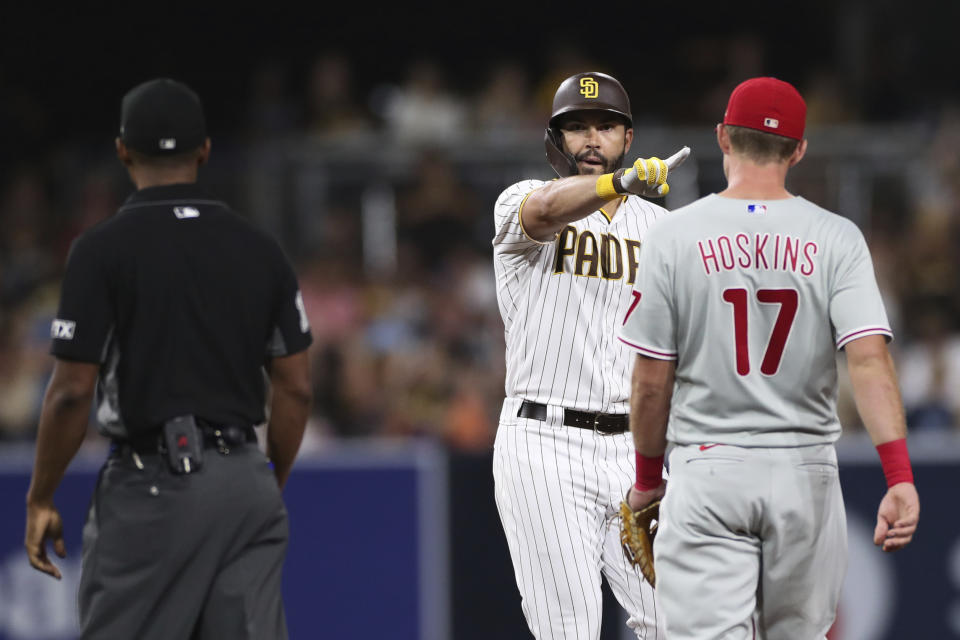 San Diego Padres' Eric Hosmer, center, gestures after hitting a double against the Philadelphia Phillies during the sixth inning of a baseball game Friday, June 24, 2022, in San Diego. (AP Photo/Derrick Tuskan)