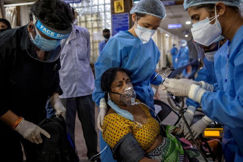 FILE PHOTO: A patient suffering from the coronavirus disease (COVID-19) receives treatment inside the emergency ward at Holy Family hospital in New Delhi