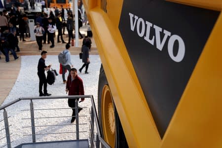FILE PHOTO: People visit heavy machinery of Volvo at Bauma China, the International Trade Fair for Construction Machinery in Shanghai