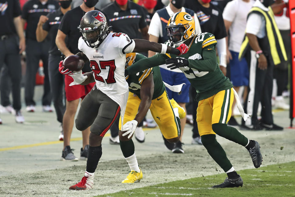 Tampa Bay Buccaneers running back Ronald Jones II (27) gets pushed out of bund by Green Bay Packers free safety Darnell Savage (26) during the second half of an NFL football game Sunday, Oct. 18, 2020, in Tampa, Fla. (AP Photo/Mark LoMoglio)