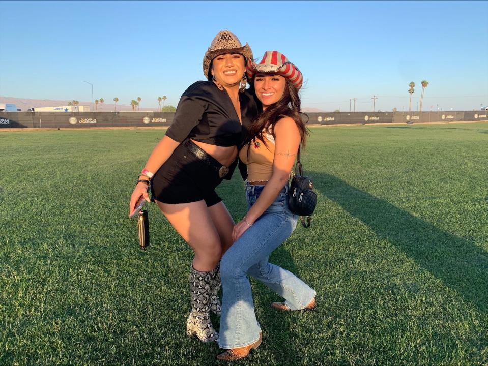 Concert-goers Daisia Guillen, left, and Jackie Escobar smile on the Coachella Crossroads grounds before seeing Toby Keith in concert.