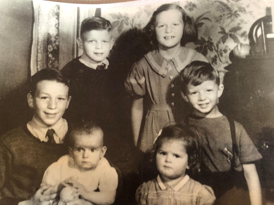 Holding his youngest sibling, Audrey, Harold Whitehouse Jr. poses with his brothers and sisters in this family photo. Harold and Audrey are the sole survivors of the group.