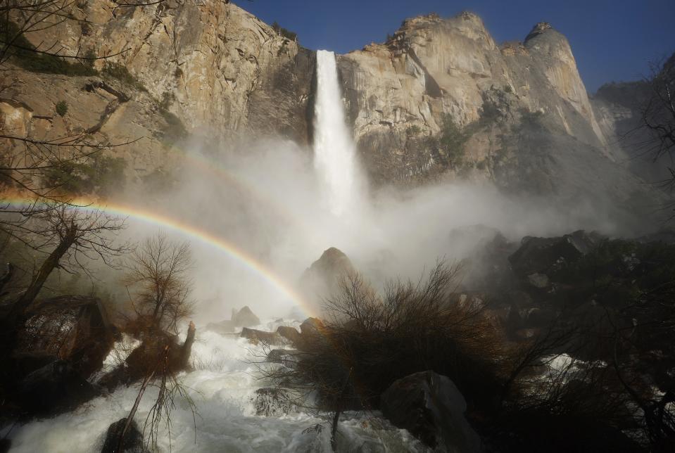 Water flows forcefully down Bridalveil Fall in Yosemite Valley, with rainbows visible in the mist, as warming temperatures have increased snowpack runoff, on April 27, 2023 in Yosemite National Park, California.