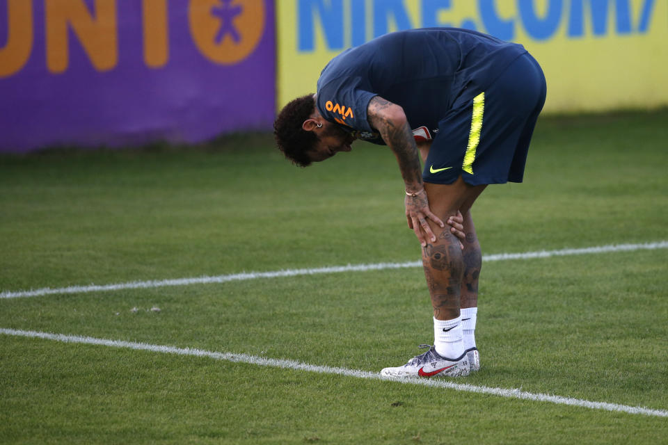 Brazil's soccer player Neymar touches his left knee during a practice session at the Granja Comary training center ahead of the Copa America tournament, in Teresopolis, Brazil, Tuesday, May 28, 2019. (AP Photo/Leo Correa)