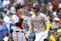 San Diego Padres' Ha-Seong Kim (7) celebrates his three-run home run, next to San Francisco Giants catcher Patrick Bailey during the second inning of a baseball game Sunday, March 31, 2024, in San Diego. (AP Photo/Denis Poroy)