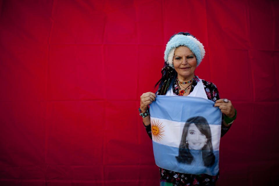 In this Oct. 3, 2018 photo, Yenni Prieto poses for a photo holding an Argentine national flag designed with an image of former President Cristina Fernandez, during a demonstration demanding improved conditions for disabled retirees, in Buenos Aires, Argentina. A battery of corruption allegations and criminal charges against former President Cristina Fernandez hasn’t fazed a strong band of hard-core backers including Prieto, who have helped make her a leading, if undeclared, contender to regain power in next year’s elections. (AP Photo/Natacha Pisarenko)