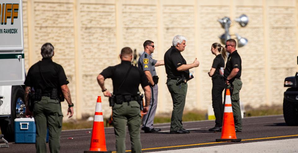Emergency officials investigate the scene of a plane crash on Interstate 75 in Naples near Exit 105 on Saturday, Feb. 10, 2024. The plane carrying five people crashed on Friday, Feb. 9, 2023. The pilot and copilot died.