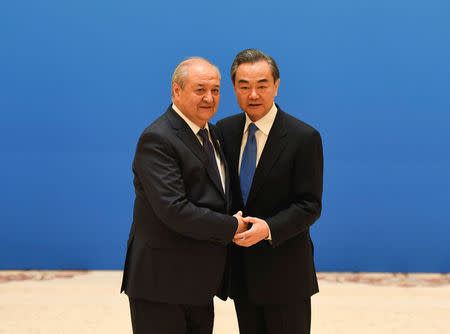 Uzbek Foreign Minister Abdulaziz Kamilov (left) shakes hands with Chinese State Councilor and Foreign Minister Wang Yi before a meeting of foreign ministers and officials of the Shanghai Cooperation Organisation (SCO) at the Diaoyutai State Guest House in Beijing, China, April 24, 2018. MADOKA IKEGAMI/Pool via REUTERS
