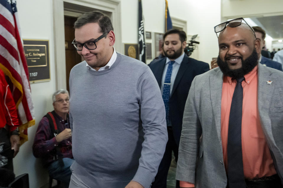 Rep. George Santos, R-N.Y., left, arrives as Republicans meet to decide who to nominate to be the new House speaker, on Capitol Hill in Washington, Tuesday, Oct. 24, 2023. (AP Photo/Alex Brandon)